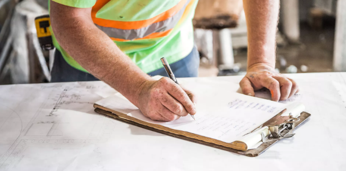 a builder checking the plans